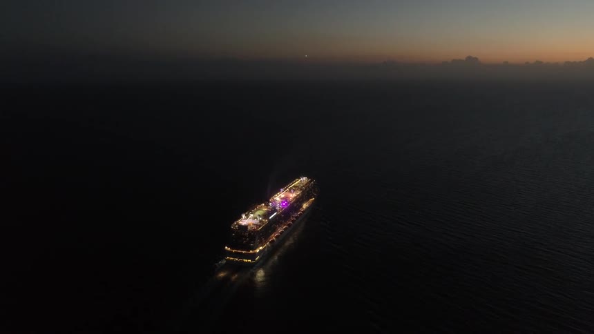 A cruise ship at night after nautical sunset