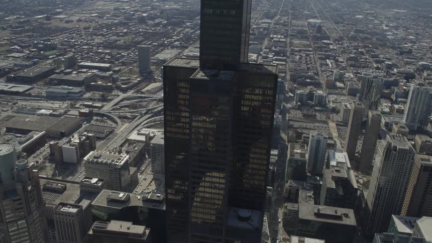 A skyscraper in a city with buildings and roads