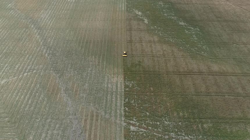 A tractor driving along a big field