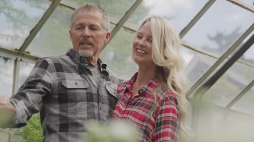 Man and women in a green house embraced