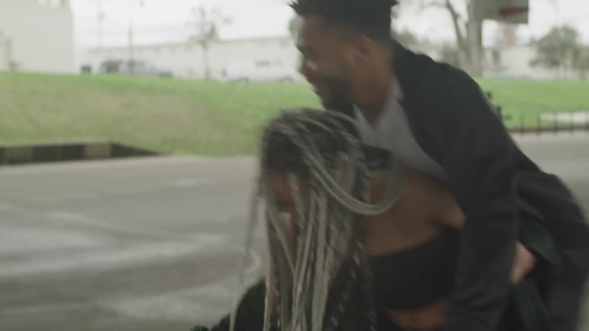 Male and female playing basketball