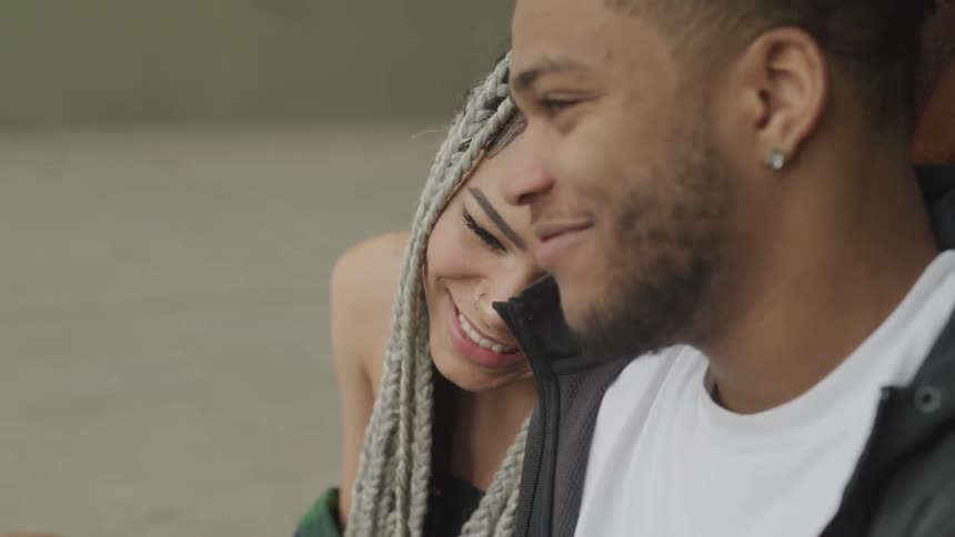 A couple smile lovingly together