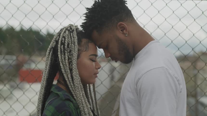 A man and woman lean their foreheads together