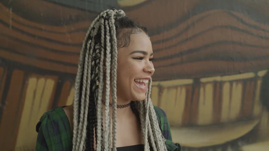A young woman laughs and turns her head