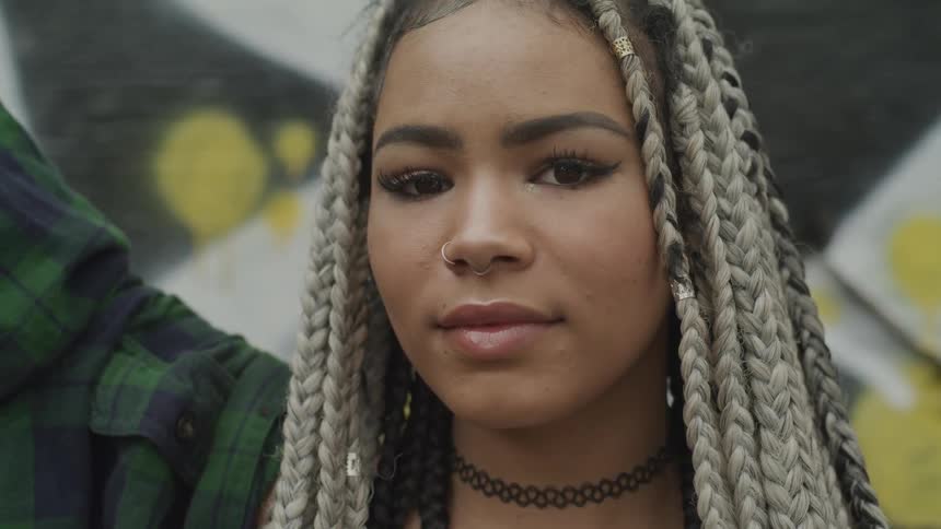 A woman looks into the camera