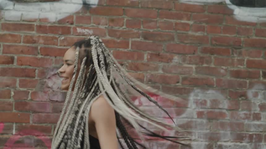 Woman happily dancing in the downtown
