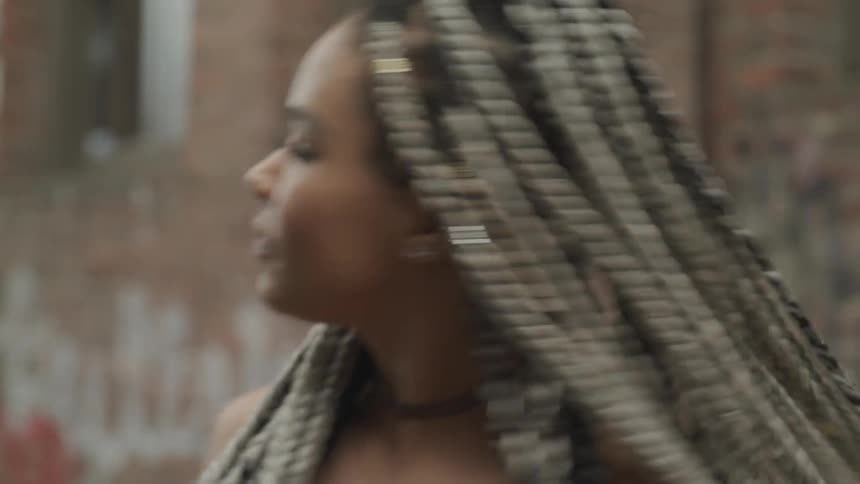 A young black woman twirls around in a circle