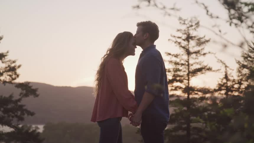 A man and woman are holding hands outdoors