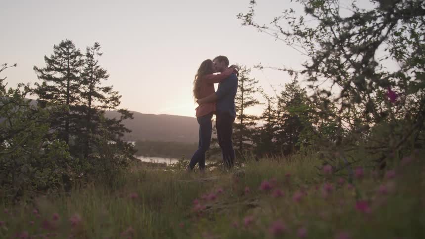 Girl and boy embraced in the woods