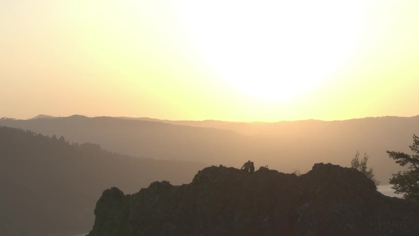 Humans ontop of a hill