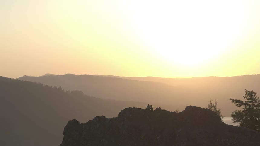 People hiking up the top of a hill