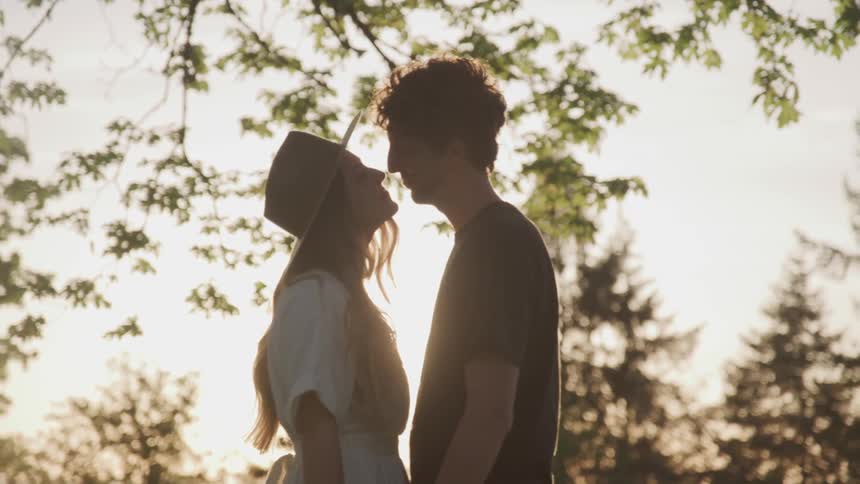 A woman and man stand close to one another