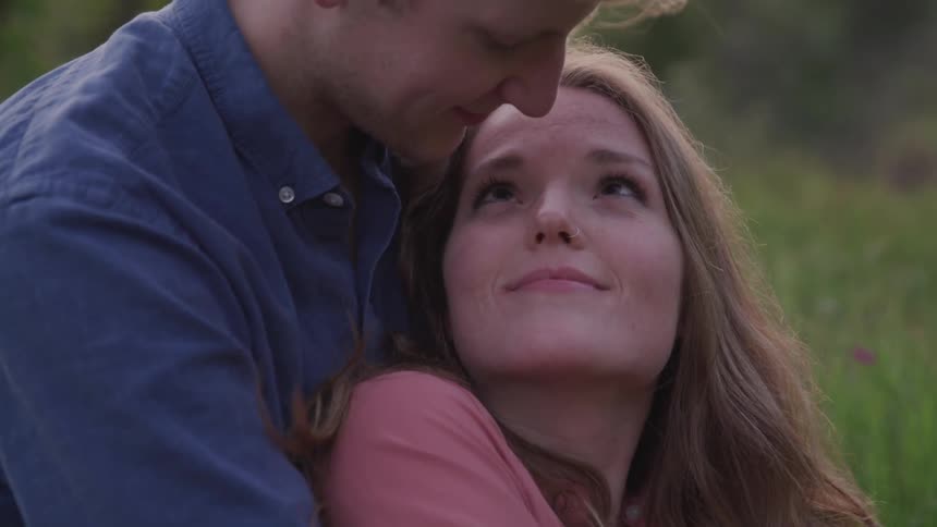 Young couple in love cuddling outdoors