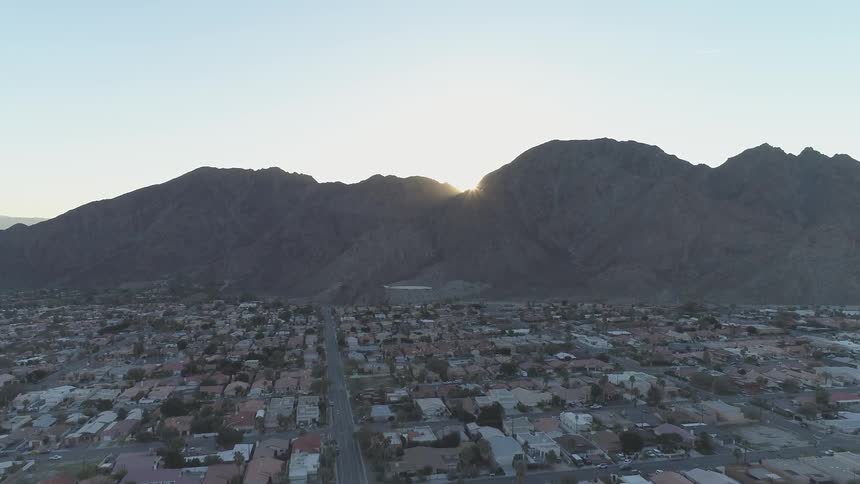 Skyline of the city while the sun goes down behind the mountains