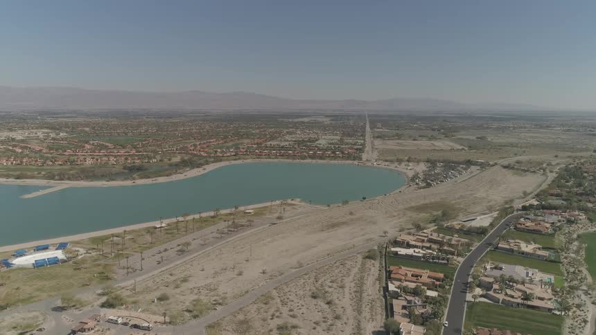 Houses sit around water in the desert