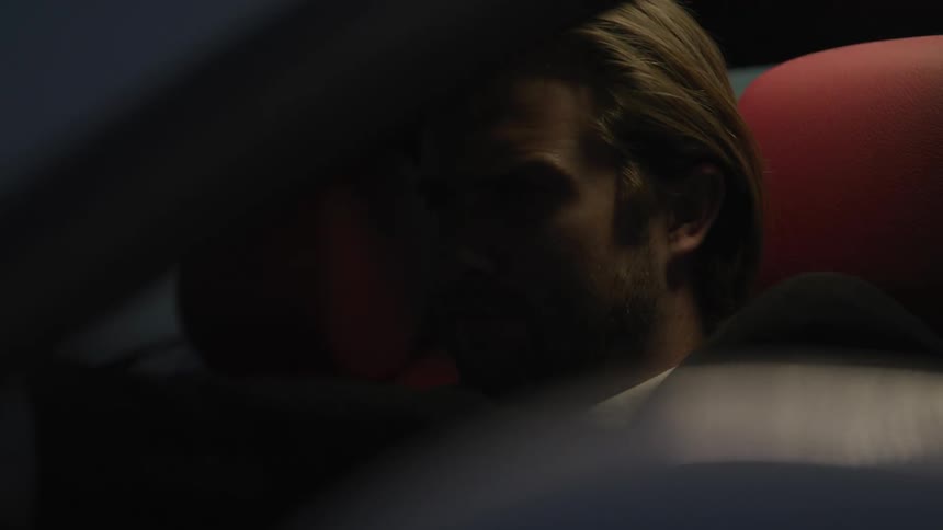 A man is driving a vehicle at night