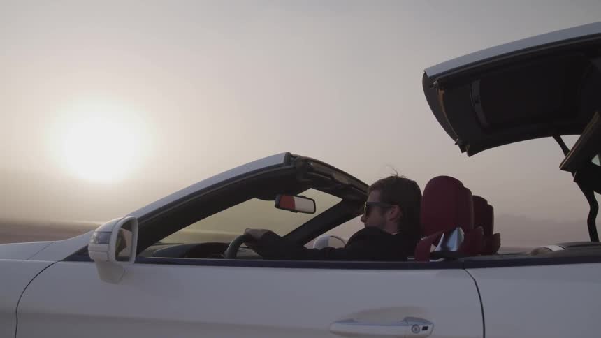 A person is driving a car outdoors