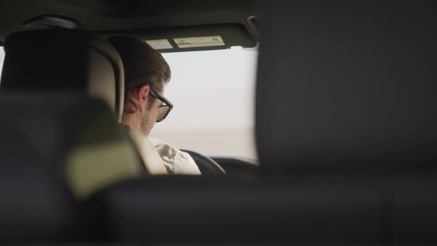 Man wearing sunglasses sit in the car during daylight