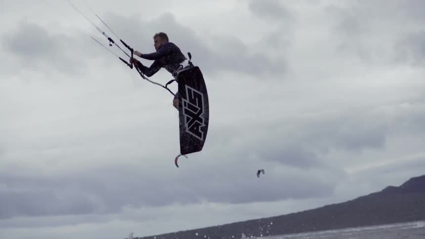 A wakeboarder attempts a trick and loses control, crashing into the water in full motion.