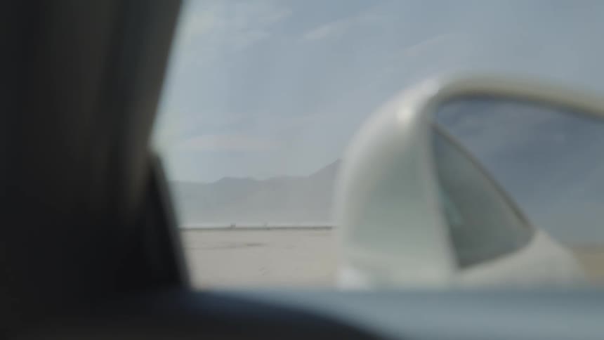 A side view mirror view of what is behind the car