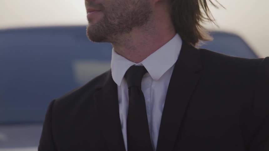 A man stands in front of a range rover on the salt flats