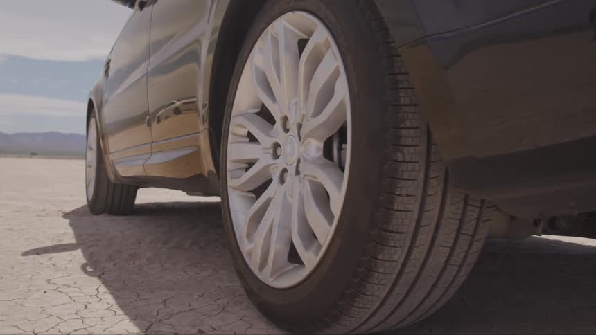 A range rover parked on desert salt flats