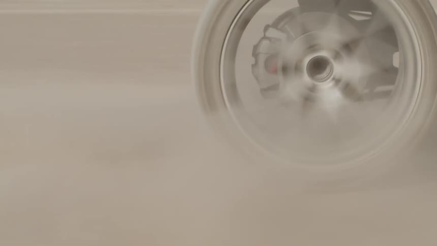A tire spins quickly from a recreation vehicle on a dirt road