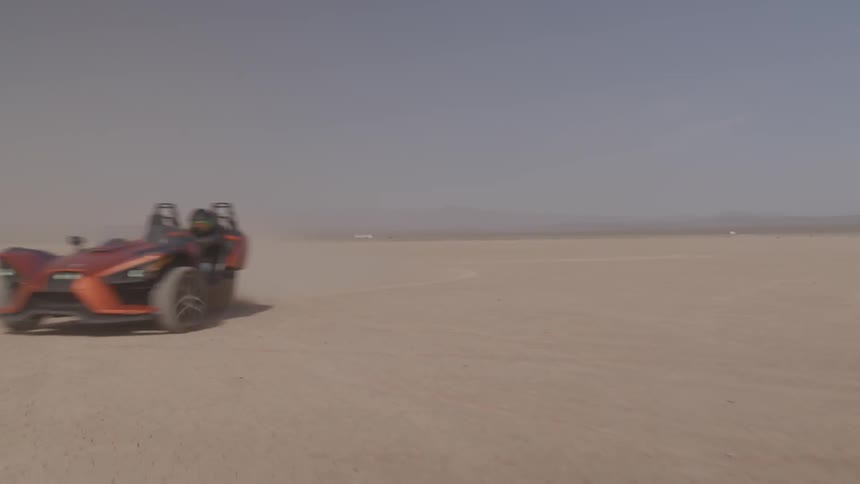 Sports car drives through a desert