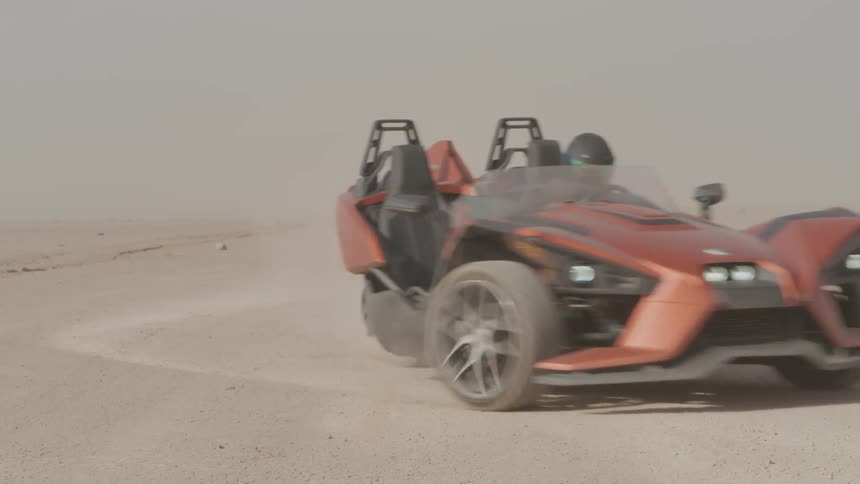 Sports car drives through a desert