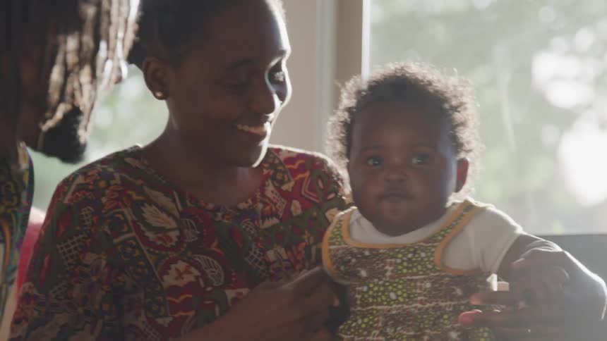 Man and woman admire female toddler