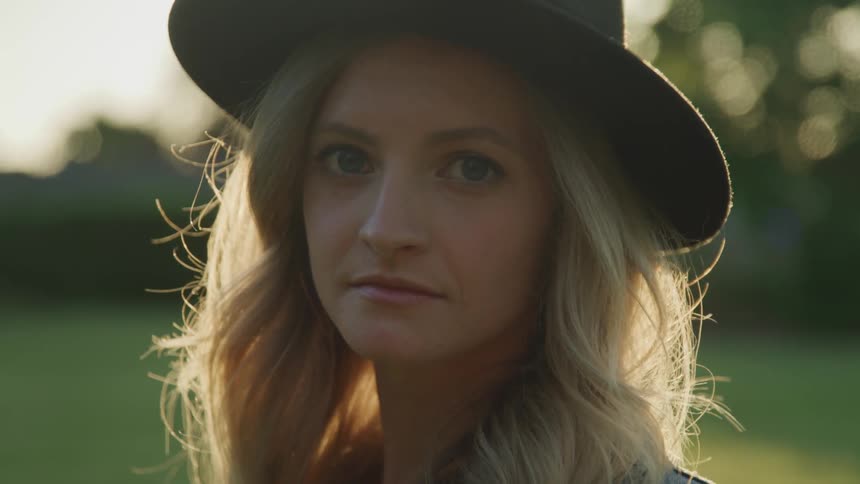 A white woman wearing a hat outdoors