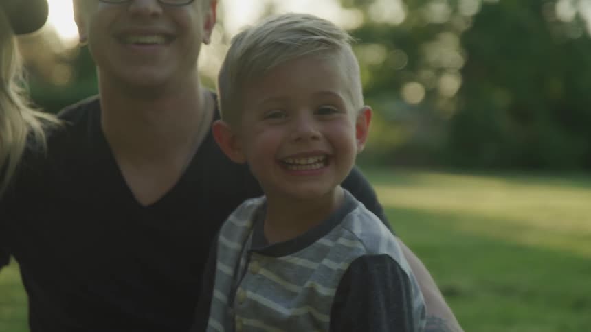 A portrait of a happy family consist of four member doing a photograph at the park