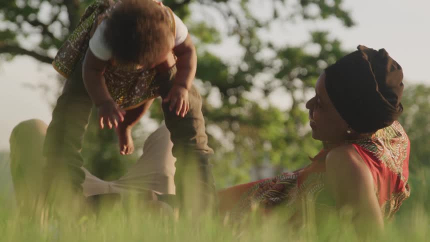 A family play with their daughter at the park