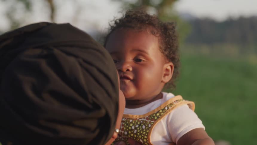 A woman bounces a baby up and down