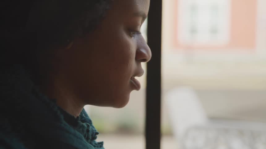 A woman looks out of the window