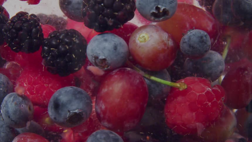 Different fruits floating in a liquid
