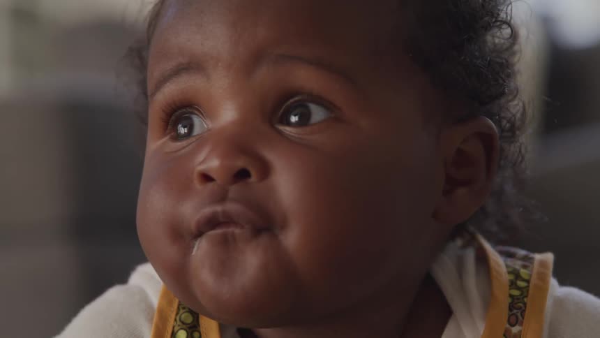 Toddler looks around and then at the camera