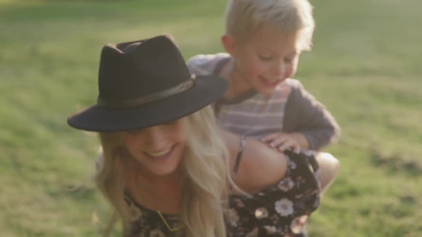 Boy riding on a woman piggy back