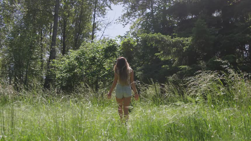 A woman is walking in a field