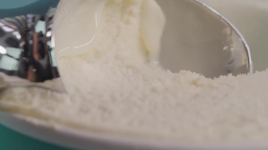 Ice cream is scooped from a pot