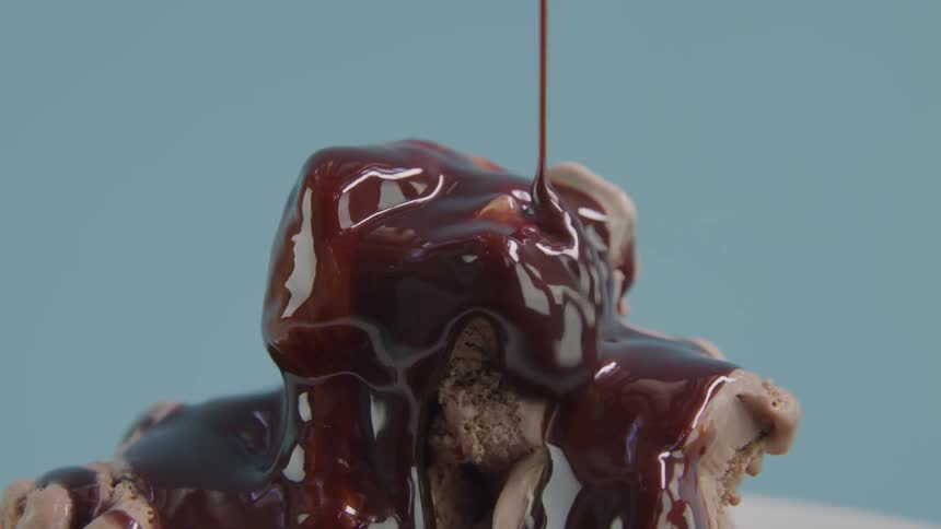 Ice cream with chocolate syrup dripping all over it