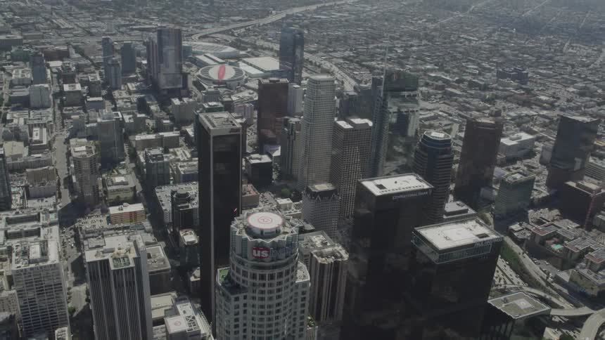 A major metropolitan area is densely packed with numerous towering skyscrapers as it is surrounded by a sprawling city