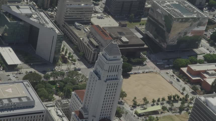 Vehicles drive down the avenue through the city below