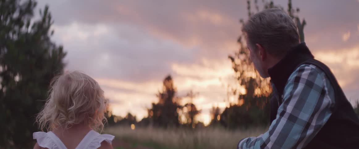 Man and girl in field