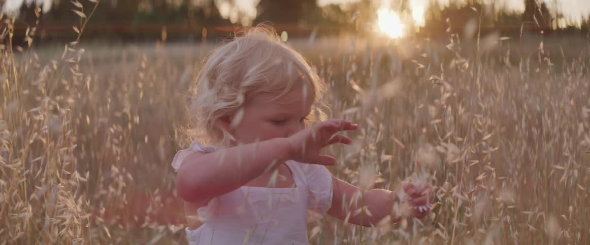 A child is playing outdoors in a field