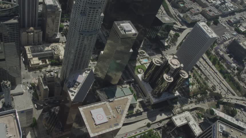 A helicopter pad sits on top of a skyscraper