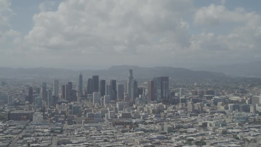 A large city with skyscrapers and buildings under a cloudy sky