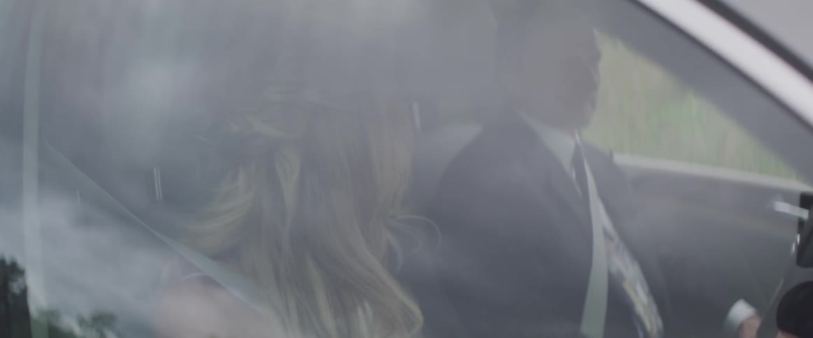 A woman and man are in a car together
