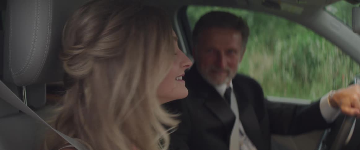 Smiling man and woman sitting in a car