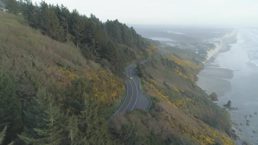 Cars are driving along the mountainside